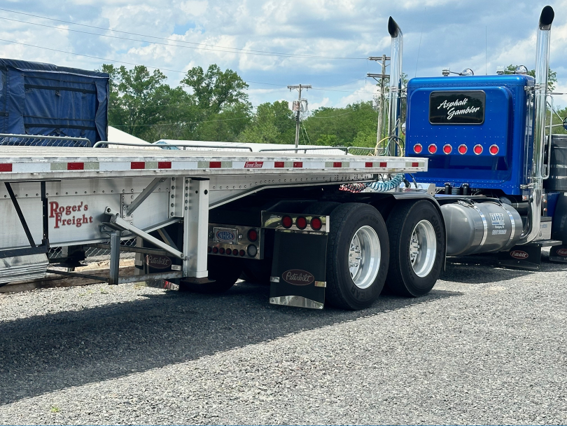 A Roger’s Freight trailer and blue truck at the yard